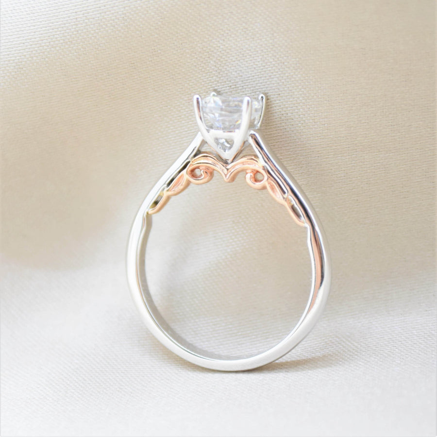 solitaire diamond ring with rose gold filigree under bridge